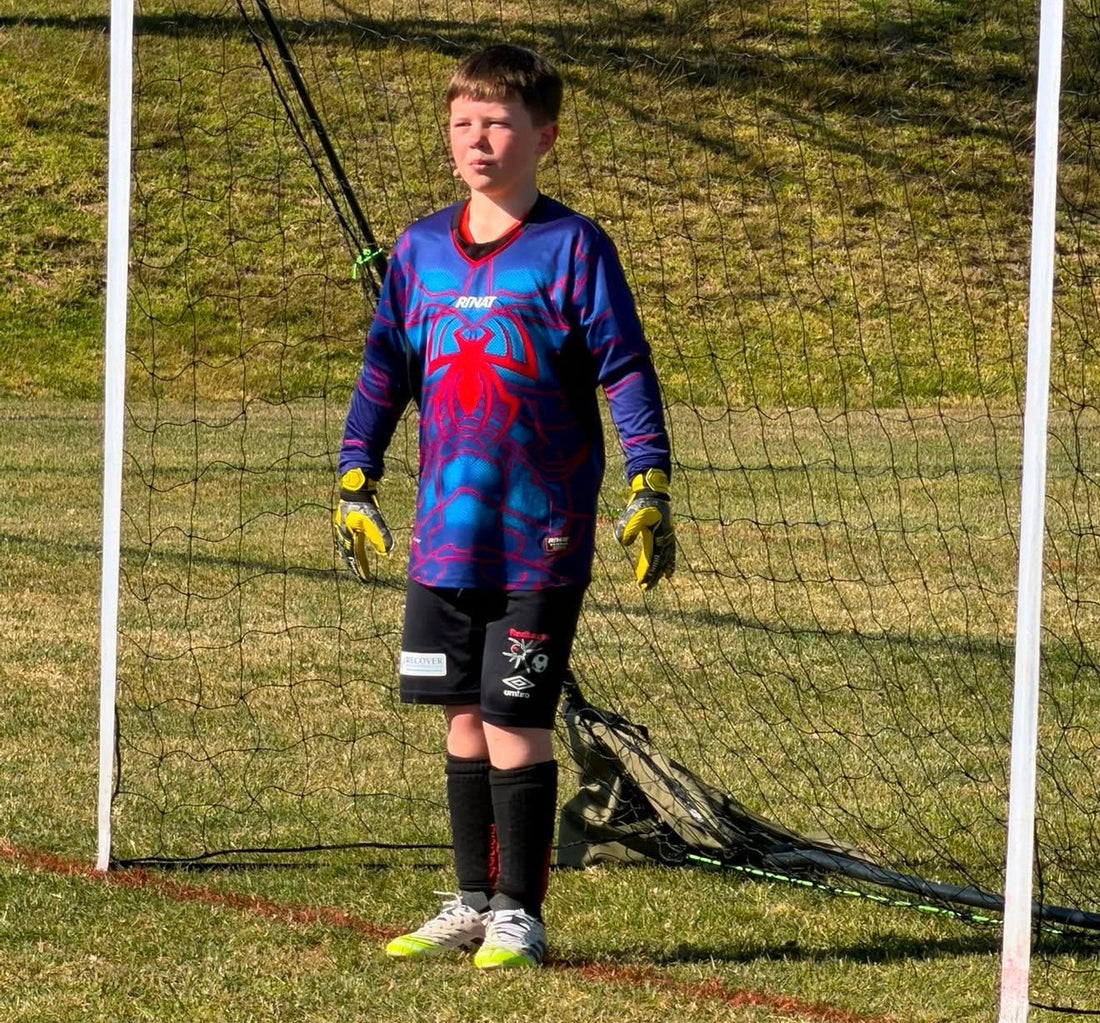 Lachlan, goalkeeper for the Yass Redbacks Under 9 Spiders, wearing Black Alpha Skins washable shin guards.