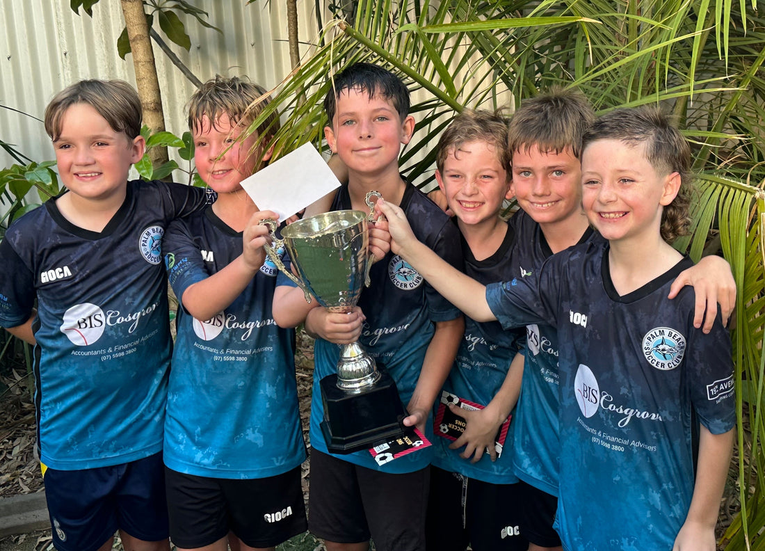 The under 9's 2025 indoor soccer division 1 team showing their trophy 